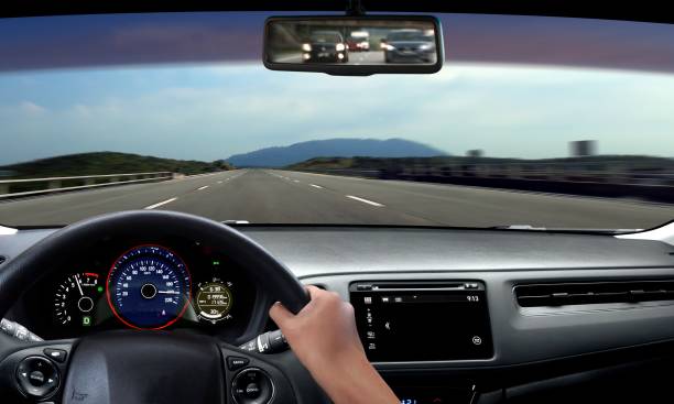 istock Hand on steering wheel driving on open road 812936280