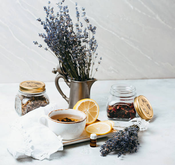 istock Rustic composition of tea, lavender, lemon and textile on concrete eco background. 812939496