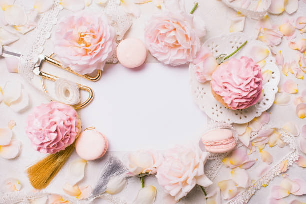 istock Pink cupcakes with roses and holiday decor in frame. Festive and bright. Wedding Celebration concept. Copy space. 812941894