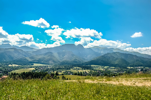 Panorama of Tatra Mountains and Zakopane in the valley. View from Gubalowka slope, near trail for tourist, Zakopane, Poland