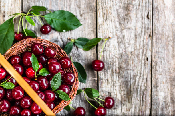 istock Organic cherries, farm fresh fruits on farmer table 812945332
