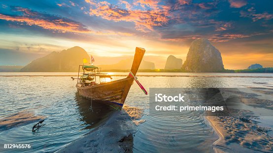 istock Beautiful sunset at tropical sea with long tail boat in south thailand 812945576