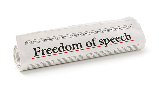 Rolled newspaper with the headline Freedom of speech
