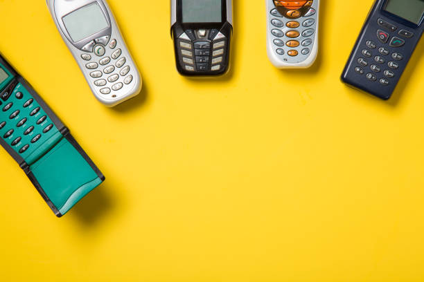 istock Old mobile phones on yellow background with free space for your text 812955002