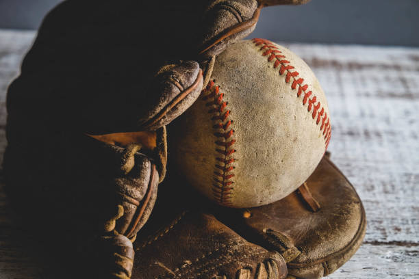 istock old Baseball and glove on wood background with filter effect retro vintage style 812957922