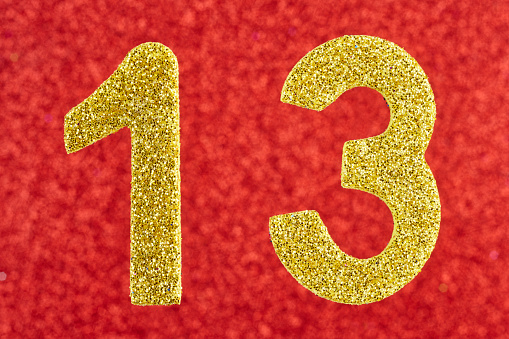 Number thirteen golden color over a red background. Anniversary. Horizontal
