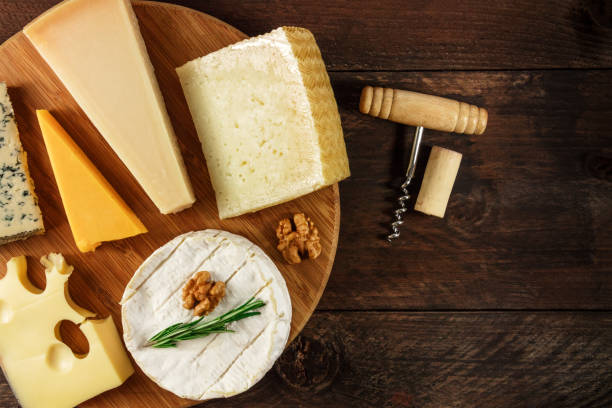 istock Selection of cheeses with corkscrew, cork, and copyspace 812964274
