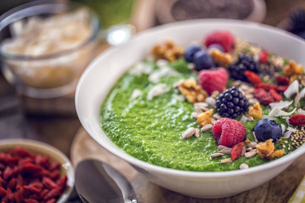 istock Green Breakfast Smoothie in Bowl with Superfoods on Top 812973732