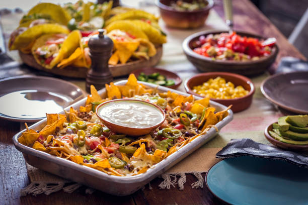 istock Eating Nachos Tortilla Chips with Salsa and Jalapenos 812974066