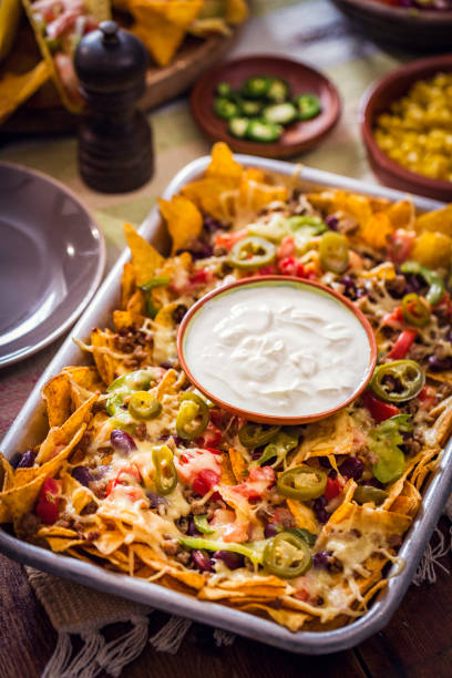 istock Eating Nachos Tortilla Chips with Salsa and Jalapenos 812974072