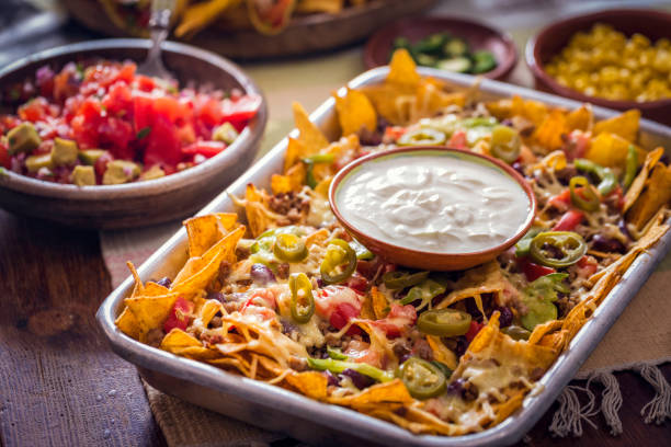 istock Eating Nachos Tortilla Chips with Salsa and Jalapenos 812974076