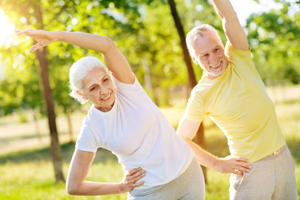 istock Joyful aged couple training in the park 812976598