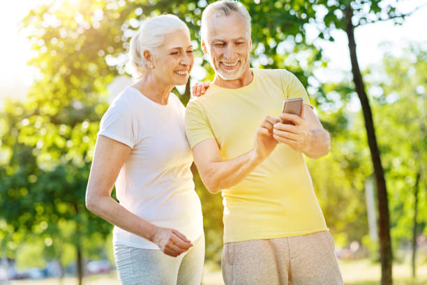 istock Positive aged couple resting in the park 812977182