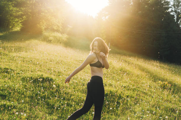 istock Woman in underwear  walking on the meadow at sunset 812977458
