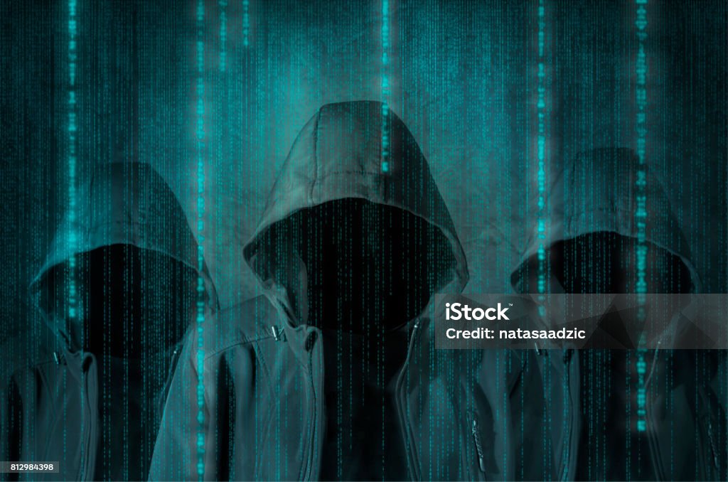 Hacker Group of hackers at work with graphic user interface around Conspiracy Stock Photo