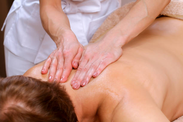 istock Young man receiving shoulder and back massage from therapist in spa 812989720