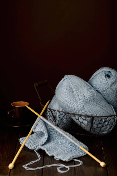 istock Knitting from light blue yarn and a cup of coffee. 812994706