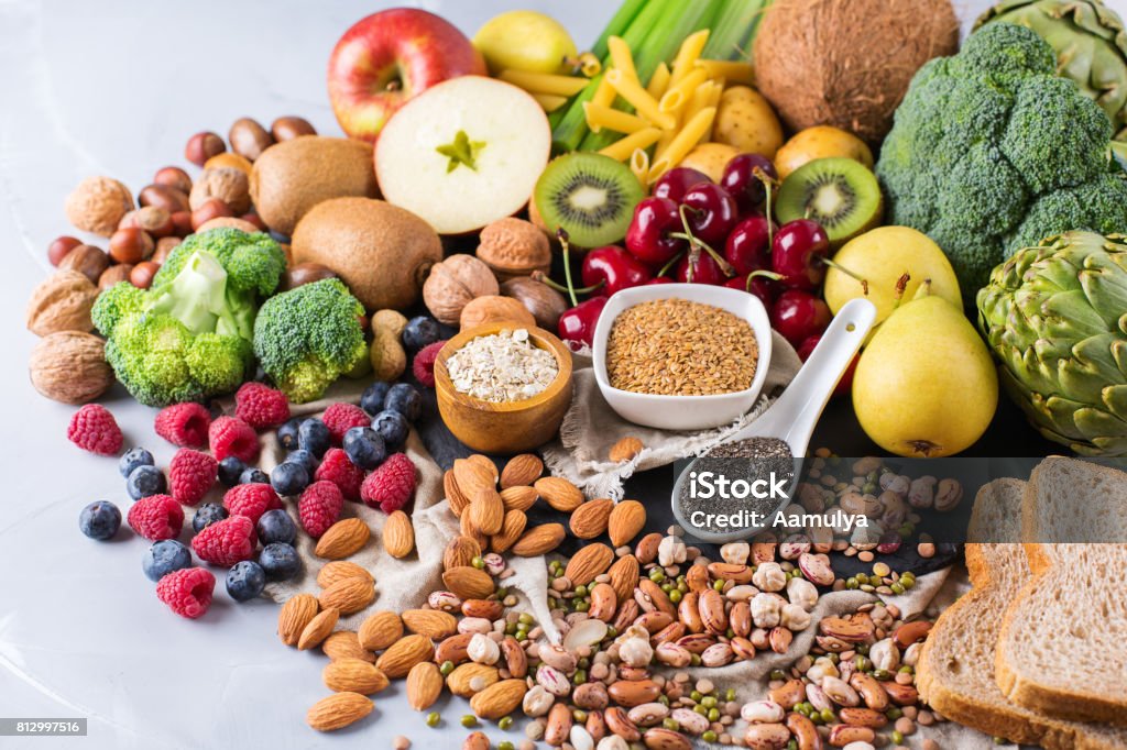 Selection of healthy rich fiber sources vegan food for cooking Healthy balanced dieting concept. Selection of rich fiber sources vegan food. Vegetables fruit seeds beans ingredients for cooking. Copy space background Food Stock Photo