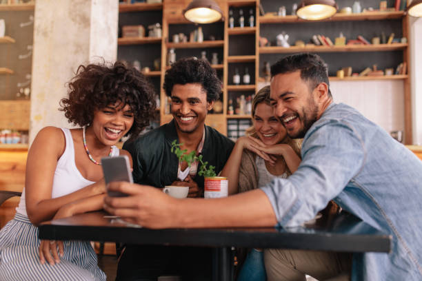 istock Group of friends meeting at cafe using cell phone 812998868