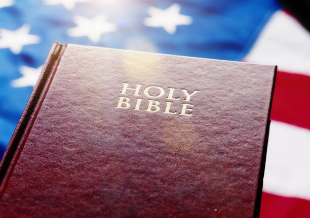 istock Holy Bible resting on American national flag 813001864