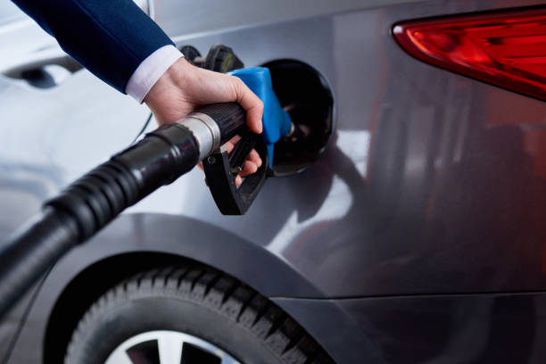istock Businessman Refueling Gas Tank, Closeup 813001898
