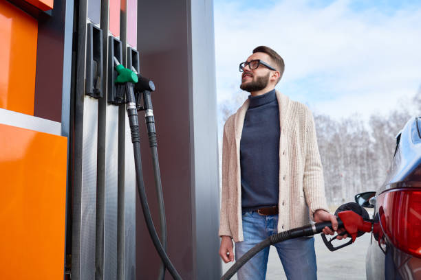 istock Smiling Man Looking at Fuel Meter at Gas Station 813002066