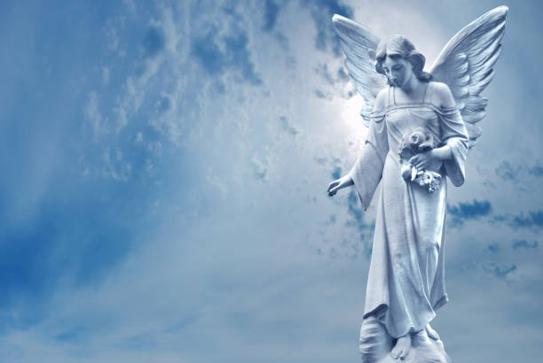istock Guardian Angel sculpture over bright sky 813004750