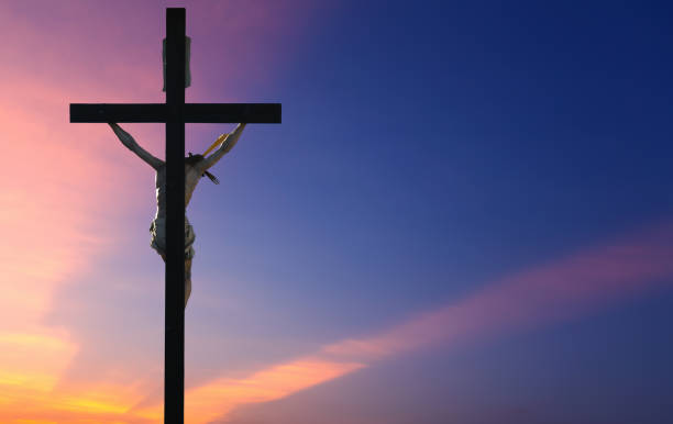 istock Jesus Christ on the cross over sunrise background 813004894