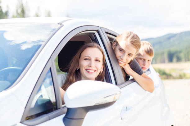 istock Happy young mom and her children sitting in a car 813005652