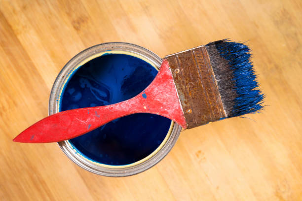 istock Full of blue paint tin and paint brush on it 813008518