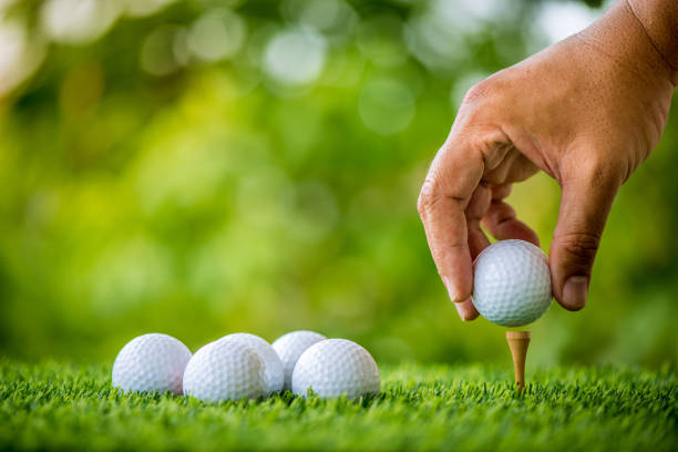 istock golf players hand placing ball on grass 813012056