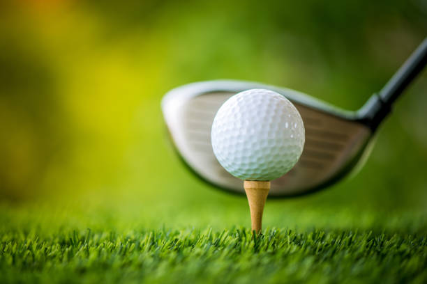 istock teeing off with golf club and golf ball 813012116