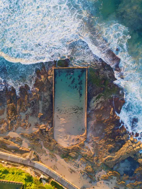 Aerial view of Cronulla tidal bath with incoming waves