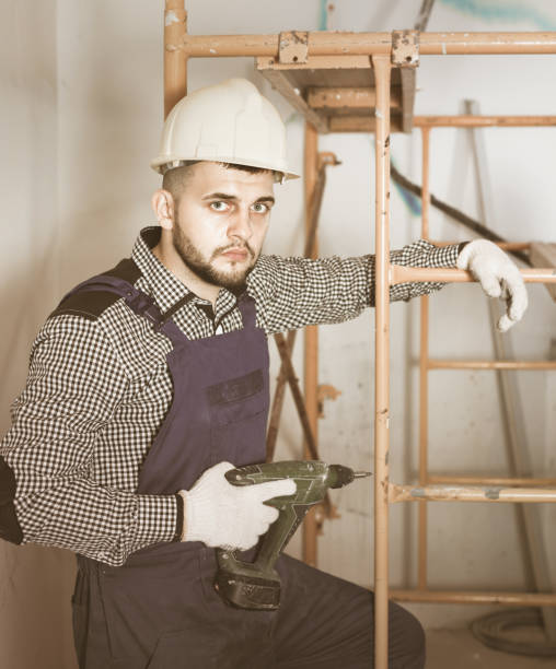 istock Male worker is ready to work with a dril 813016256