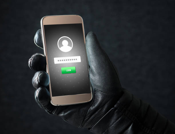 istock Identity theft and cyber security concept. Mobile hacker and criminal login to persons online social media account or personal information and data with smartphone. Thief with black leather gloves. 813024694