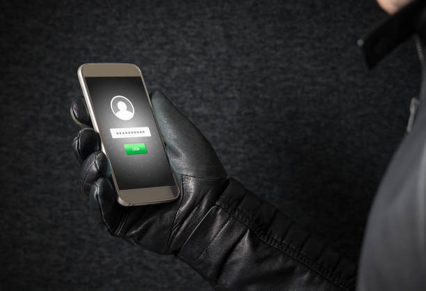 istock Identity theft and cyber security concept. Mobile hacker and criminal login to persons online social media account or personal information and data with smartphone. Thief with black leather gloves. 813024722
