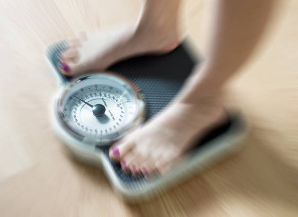 Female feet on scale with dramatic blur zoom effect.