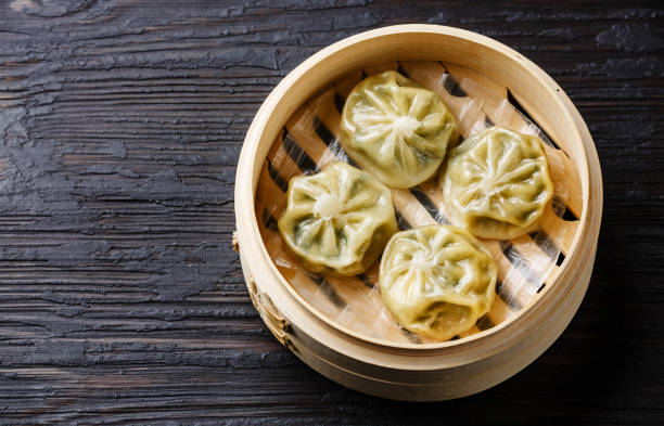 istock Steamed dumplings Dim Sum in bamboo steamer 813025106