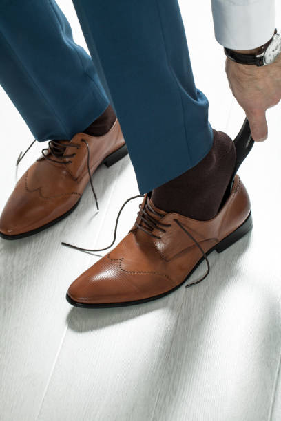istock Man laces his shoelaces 813037964