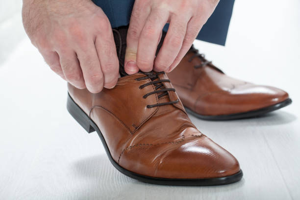 istock Man laces his shoelaces 813037976