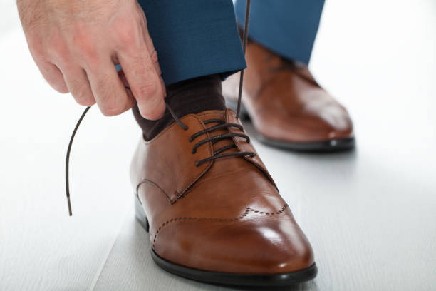 istock Man laces his shoelaces 813038054