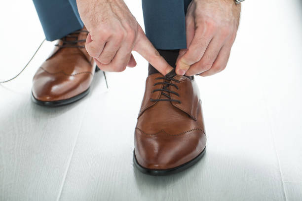 istock Man laces his shoelaces 813038108