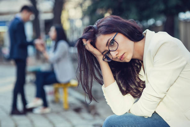 istock Girl looking sad and holding her head in hand 813038340