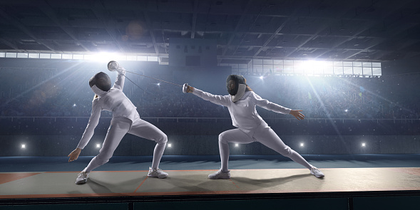 Fencing competitive duel. Female fencer fight on big professional stage. They are wearing an unbranded fencing suit.