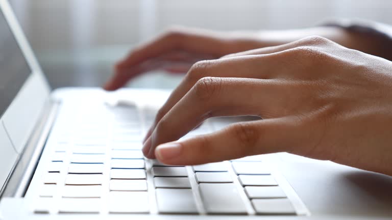 Woman Typing On Laptop Keyboard,Close-up