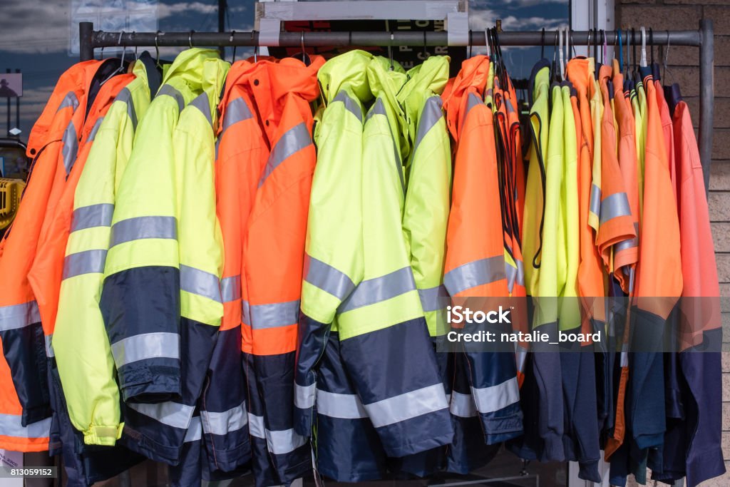 Protective clothing on rack Full frame view of yellow and orange high visibiity protective clothing on rack Protective Workwear Stock Photo
