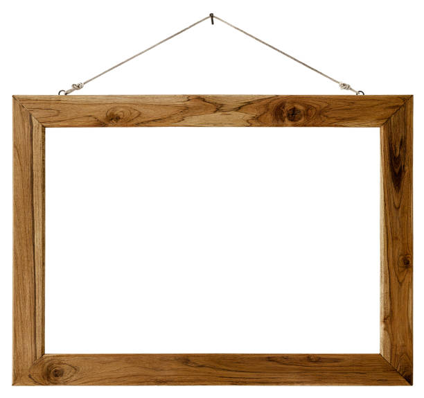 An old weathered wood picture frame hangs by old rope from a rusty nail, isolated on white, clipping path included. The frame is rustic with lots of grain detail.