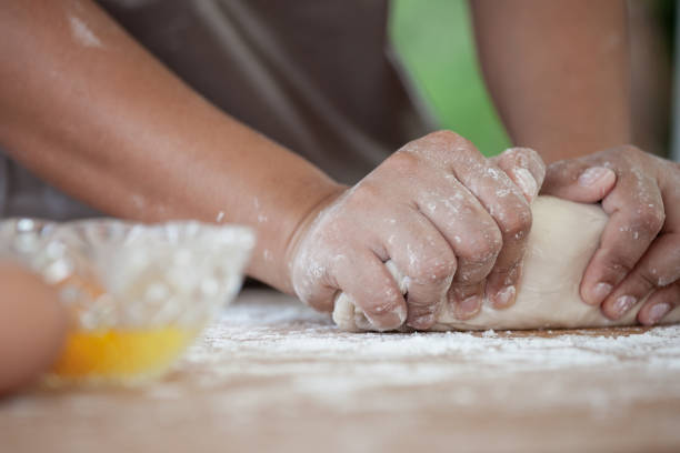 istock Woman hands kneading dough prepare for baking cookies in the kitchen 813074056