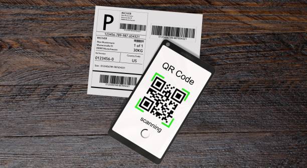 istock QR Code scanning from a shipping stickers with modern touchscreen smartphone on a wooden business table 813078954
