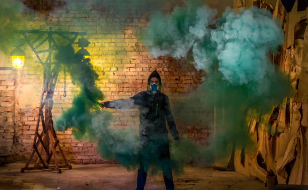 istock Young Man In Gas Mask With Smoke Bomb 813081412